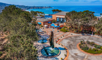 arial view of Birch Aquarium with whale statue in front and blue ocean stretching behind